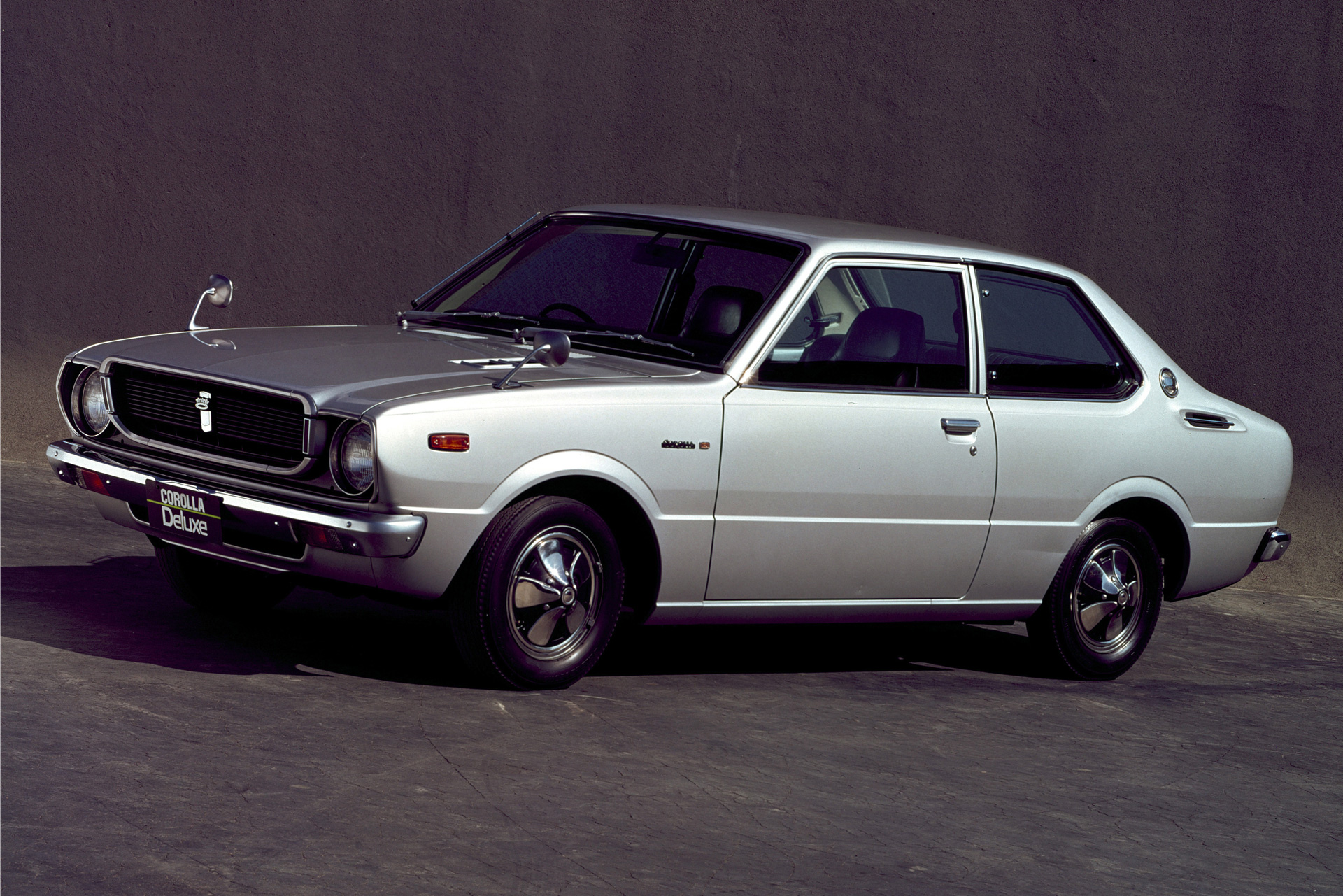 Toyota Corolla fra 1970'erne i lyst metalgråt karrosseri.